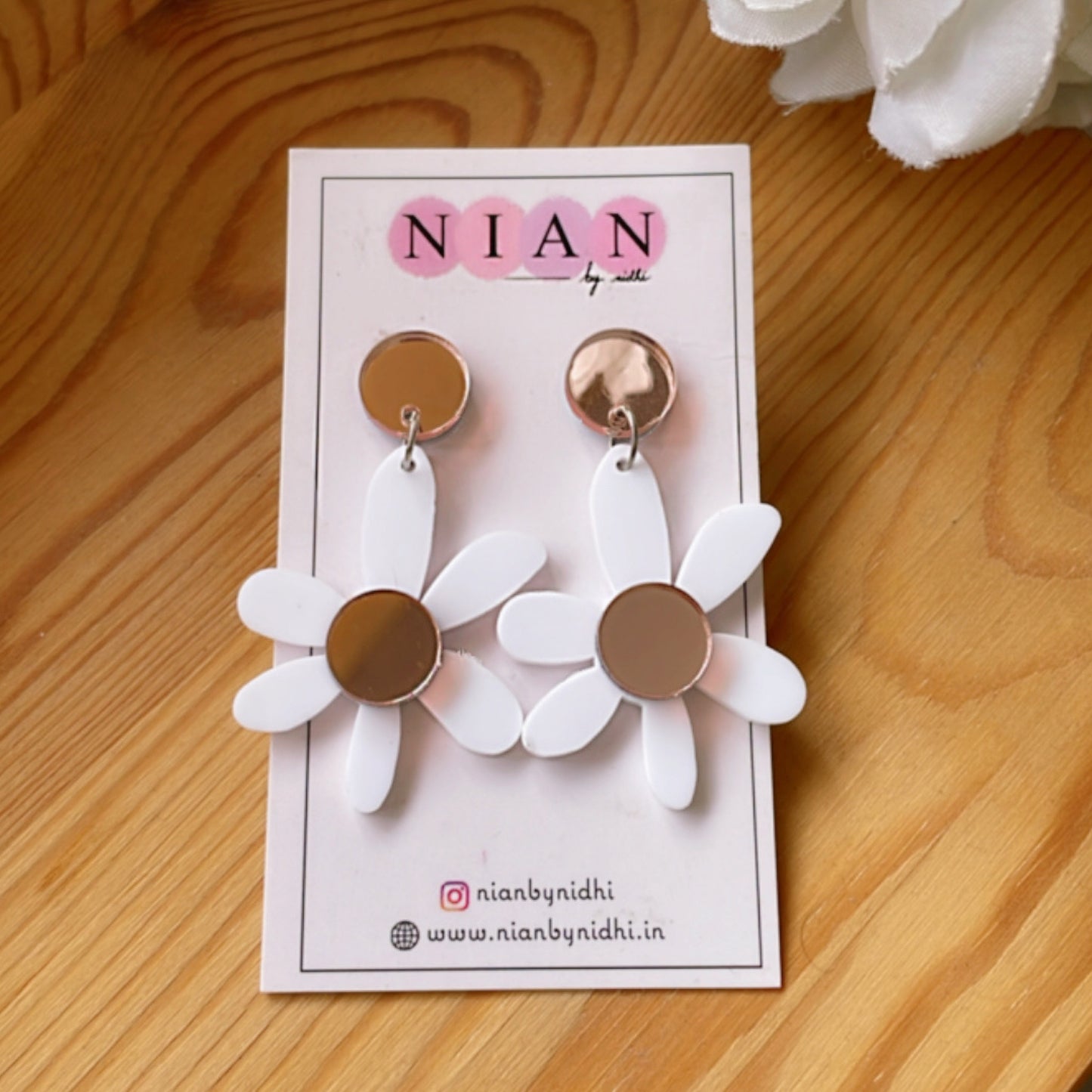 Lush Lily Earrings - White and Rosegold - Nian by Nidhi - placed in a brown background