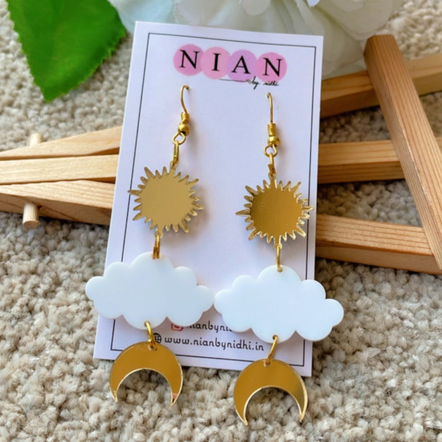 Shining Sky Danglers - Glossy Gold and White - Nian by Nidhi - placed in a light beige background